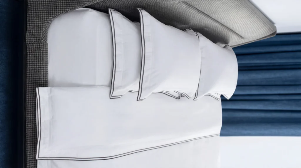 Breathable cotton pillowcases on bed with soft texture and smooth finish for skin-friendly sleep