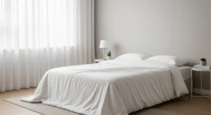 Minimalist bedroom with white breathable bed sheets and duvet cover suitable for hot UAE weather
