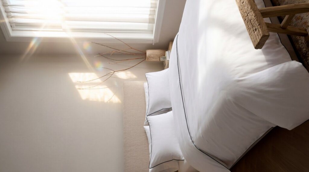 Luxury organic cotton bedding set in a modern UAE bedroom with breathable white sheets and elegant hotel-style finish