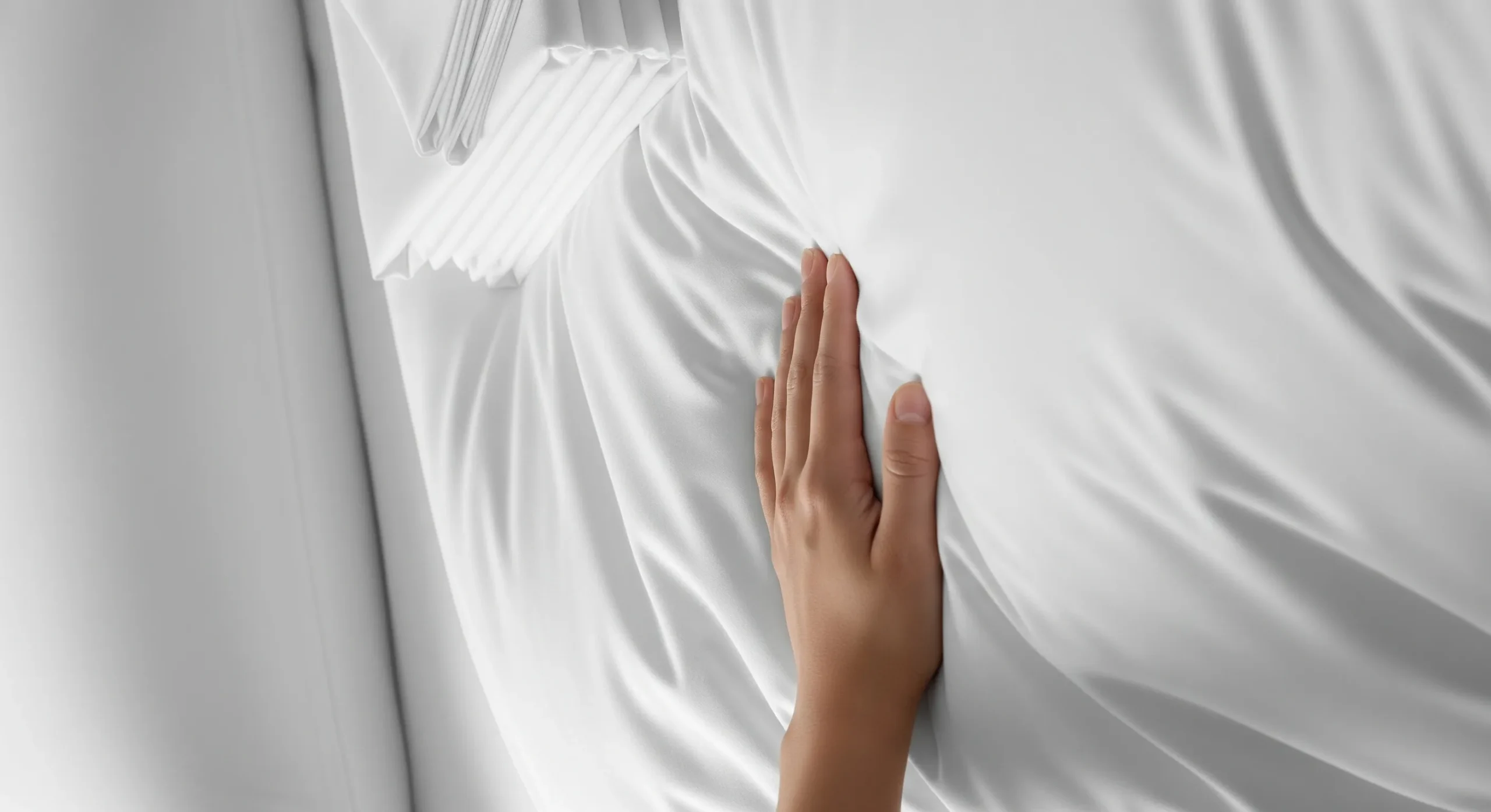 Bedsheet set Dubai, A hand feeling the softness of organic cotton bedsheet